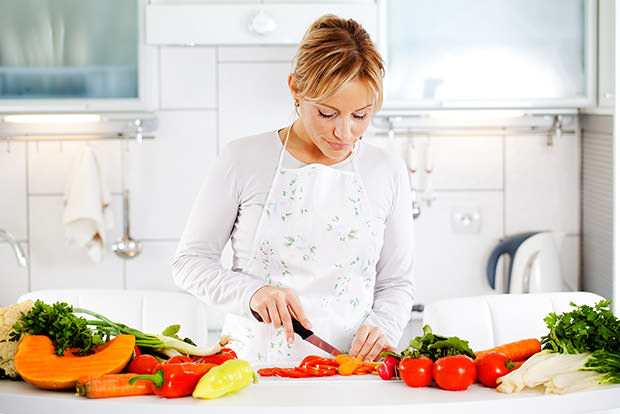 Woman chopping vegetables in a kitchen